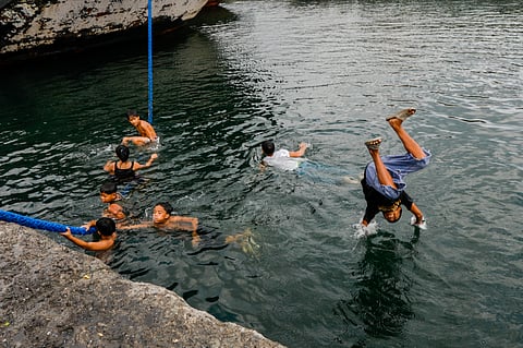 Children and youth swim at the port area of Baseco in Manila Bay.