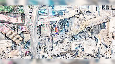 Residents of Barangay Obrero in Quezon City try to salvage anything of value after firefighters were able to douse the huge blaze that engulfed the residential area last Saturday night.