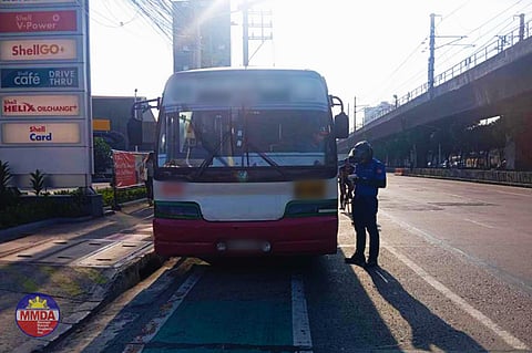 Members from the Metropolitan Manila Development Authority Quick Reaction Unit flag some drivers for various traffic violations along EDSA in Quezon City. 
