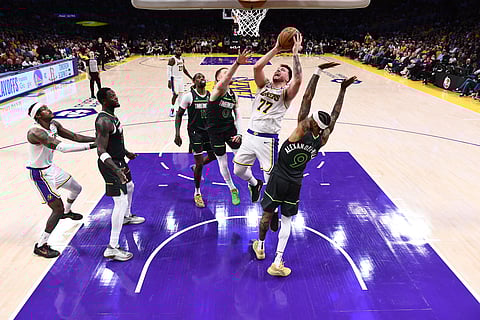 OS ANGELES, CA - APRIL 19: Luka Doncic #77 of the Los Angeles Lakers drives to the basket during Round 1, Game 1 of the 2025 NBA Playoffs against the Minnesota Timberwolves on April 19, 2025 at Crypto.Com Arena in Los Angeles, California.