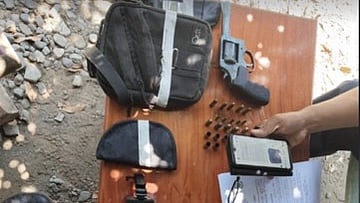 Police officers document seized items including a .38 caliber revolver, ammunition, and suspected drug-related materials on a table during a search warrant operation in Barangay Medina, Dingras, Ilocos Norte, on 23 April 2025. A map and timestamp from a GPS camera are visible in the image.