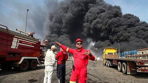 Thick, black smoke rises as rescuers arrive near the source of an explosion at the Shahid Rajaee port dock southwest of Bandar Abbas in the Iranian province of Hormozgan on 26 April 2025. 