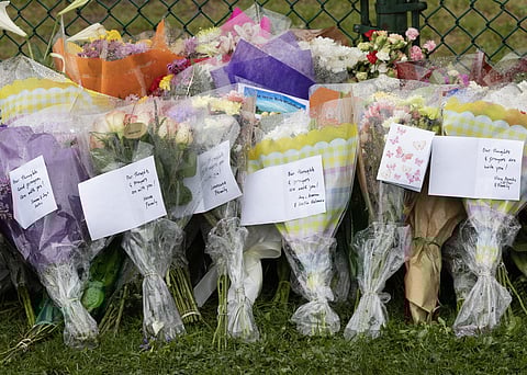 Bouquets of flowers with handwritten condolence notes line a fence at a makeshift memorial near the site of the Lapu Lapu Festival tragedy in Vancouver, where an SUV plowed into a crowd on 26 April 2025, killing 11 people and injuring many others.