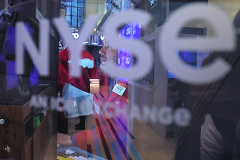 
US markets had forged higher following strong results from tech giants Microsoft and Meta that helped offset lingering economic worries. New York Stock Exchange traders monitor the market during morning trading. 