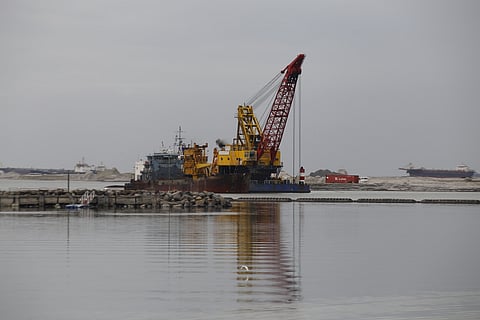 HEAVY equipment operates at a reclamation site along Manila Bay in Pasay City, in this file photo as the Department of Environment and Natural Resources halts progress following a University of the Philippines study confirming environmental impacts, including heightened flood risks. 