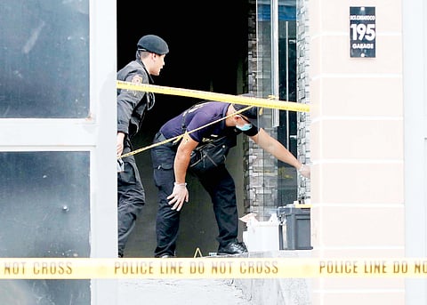 Operatives from the Quezon City Police District Explosive Ordnance Disposal unit check on debris following an alleged grenade explosion at an establishment along Scout Chuatoco in Quezon City on Thursday.