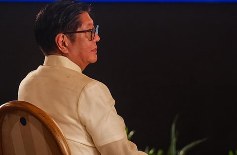 A reflective Marcos, shadowed by promises unmet and alliances undone.