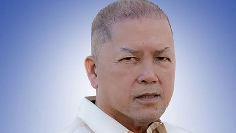 Portrait of Antonio “Tony” Kho wearing a barong Tagalog against a blue gradient background.