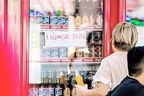 A LIQUOR ban signage at a store in Manila is posted as sales and consumption of alcohol are illegal during 11 and 12 May. 
