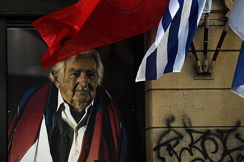 View of a huge image of the late Uruguayan former president (2010-2015) Jose 'Pepe' Mujica at the Frente Amplio party headquarters in Montevideo, on May 13, 2025, following the announcement of his death. Uruguay's former president (2010-2015) Jose Mujica, a former guerrilla fighter and icon of the left in Latin America, died at the age of 89 on May 13, 2025, the government announced. The farmer dubbed the "world's poorest president" during his presidency for his modest lifestyle had been diagnosed with cancer of the esophagus in May 2024.

