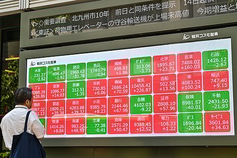 Searching for clues Electronic board showing share prices on the Tokyo Stock Exchange along a street in central Tokyo. Asian equities, catching up with big advances Monday on Wall Street, saw further rallies Tuesday, although Hong Kong dropped nearly two percent on profit-taking.