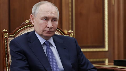 Russian President Vladimir Putin sits at a desk during a meeting with Promsvyazbank’s CEO at the Kremlin in Moscow on 15 May 2025, in a pool photograph released by Russian state agency Sputnik.