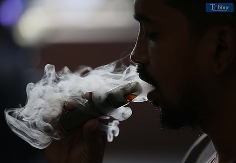 (May 19 2025) A man blow thick smoke from vape on Monday May 19 2025, Senate President vape tax adjustment to be approved when senate returns to session. Photo/Analy Labor