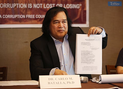On Wednesday, 21 May 2025, during a press conference in Quezon City, Dr. Carlo Batalla, chairman of Crimes and Corruption Watch International, presents documents his group filed before the Office of the Ombudsman against top officials of the Department of Public Works and Highways–Region 6 and executives of a private construction firm over alleged irregularities involving P2.4 billion in bidding contracts.