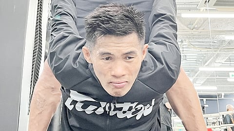 
World champion Pedro Taduran gets quality work from his chief trainer Carl Peñalosa Jr. during Thursday’s workout in Osaka. 