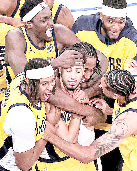 TYRESE Haliburton (middle) and the Indiana Pacers celebrate after pulling off a come-from-behind win over the New York Knicks in overtime, 138-135, in Game 1 of their NBA Eastern Conference best-of-seven finals series.    