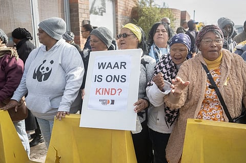 A protester holds a placard reading "Where is our child?" written in Afrikaans, as she gathers with other protesters outside the court, in Saldanha Bay on May 29, 2025. A South African court on May 29, 2025 sentenced Raquel "Kelly" Smith to life in prison for kidnapping and selling her six-year-old daughter, in a case that horrified the country.
Joshlin Smith went missing in February 2024 from her home in Saldanha Bay, a fishing town 135 kilometres (85 miles) north of Cape Town, and has never been found.
