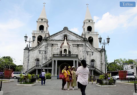  Local tourists offer prayers at the National Shrine of Our Lady of Candles in Jaro, Iloilo on 31 May 2025. The image of Nuestra Señora de la Candelaria, perched atop the cathedral’s façade, holds the distinction of being the first Marian image in the Philippines and Asia to be canonically crowned by a Pope—Saint John Paul II. 