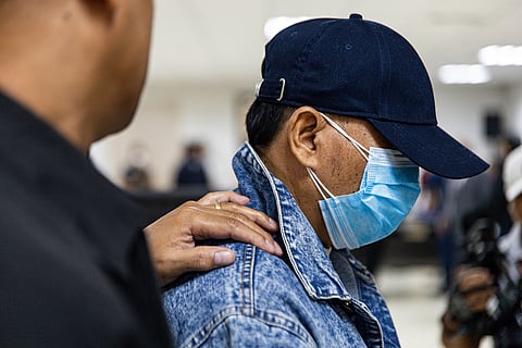 One of the suspects who allegedly conspired to kidnap three foreign nationals in Nasugbu, Batangas is presented to the media by officials from the National Bureau of Investigation-Organized and Transnational Crimes Division and the Philippine National Police-Anti-Kidnapping Group.