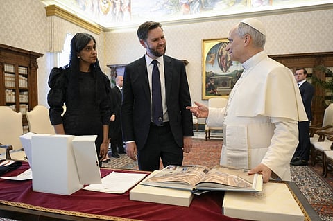 This photo taken and handout on 19 May 2025 by The Vatican Media shows US Vice President JD Vance and his wife Usha exchanging gifts during a private audience with Pope Leo XIV in The Vatican.
