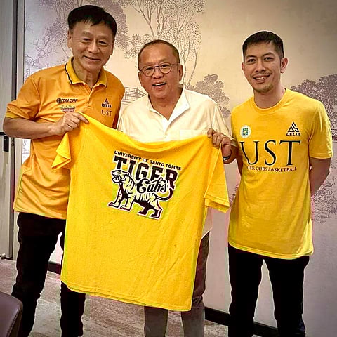STRONG Group Athletics chief Frank Lao (middle) smiles after agreeing to bankroll the program of the UST Tiger Cubs starting Season 87 of the UAAP junior boys basketball tournament. Also shown is UST coach Manu Iñigo (right) and team manager Jarvis Co.