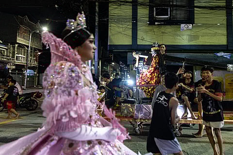 A replica of the Black Nazarene image passes by Andrei Cruz during the Sagayla procession in Sampaloc, Manila, on Sunday, 1 June 2025.