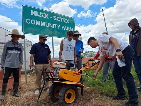 COMMUNITY members and volunteers at the NLEX-SCTEX Community Farm receive hands-on training with new farming equipment to support sustainable food production and livelihood.