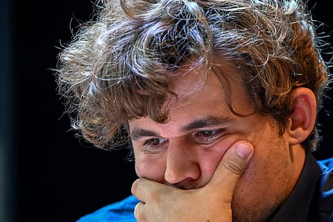 Norway's chess grandmaster Magnus Carlsen gestures during a game in the Tata Steel Chess India tournament in Kolkata on 17 November 2024.