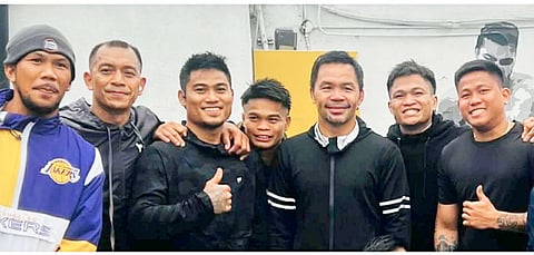 Manny Pacquiao strikes a pose with some of the Filipino boxers seeing action in the undercard of his 19 July world title shot at the MGM Grand in Las Vegas.