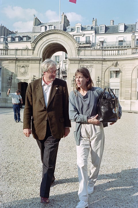 French director Bertrand Tavernier and French actress and singer Jane Birkin arrive at the Elysée Palace where they are received by the President of the Republic François Mitterrand before the 43rd Cannes Film Festival, on May 9, 1990.