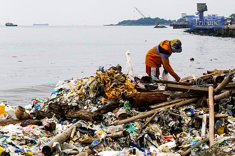 A man collects recyclable plastics along the seawall in Navotas City on Friday, 7 June 2025, a day before World Oceans Day. Plastic pollution continues to threaten marine life, with an estimated 11 million metric tons entering the ocean each year, compounding the 200 million metric tons already circulating in marine environments.