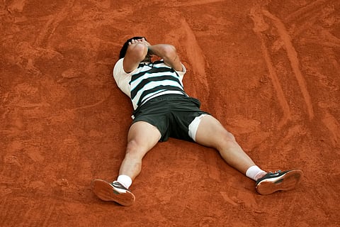 SPAIN's Carlos Alcaraz celebrates after winning the men's singles final match against Italy's Jannik Sinner on day 15 of the French Open tennis tournament on Court Philippe-Chatrier at the Roland-Garros Complex in Paris on June 8, 2025.
