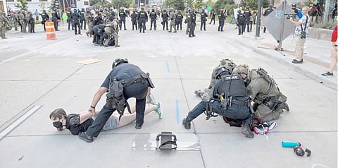 PEOPLE look at the spot where a car exploded in front of the City Hall in Corinto, Cauca department, Colombia, on 10 June 2025. 