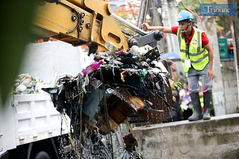 Metropolitan Manila Development Authority (MMDA) workers use both manual tools and a backhoe to remove trash from Maligaya Creek in Caloocan on Wednesday, as part of Bayanihan sa Estero—an ongoing cleanup drive aimed at clearing Metro Manila waterways to help prevent flooding. 