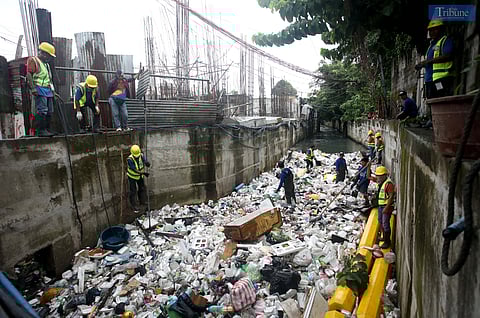 Metropolitan Manila Development Authority (MMDA) Workers manually and use backhoe to scoop out trash  as part of the Bayanihan sa Estero, a program to clean waterways in Metro Manila as part of the agency's flood mitigating measures. Photo/Analy Labor