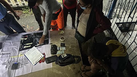 ZAMBALES police examine the P5 million worth of illegal drugs seized from a suspected peddler during a buy-bust operation in San Marcelino town Thursday.