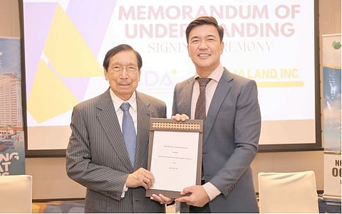 Bases Conversion and Development Authority president Joshua Bingcang (right) and AMA Land Inc. chairman emeritus Dr. Amable Aguiluz V are shown after signing a Memorandum of Understanding that aims to explore and develop new affordable housing opportunities within New Clark City.