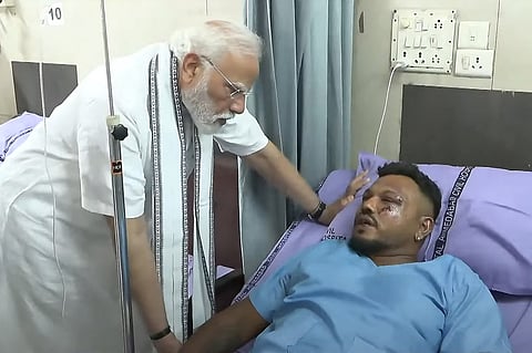 THIS screengrab of video footage taken and released by the Narendra Modi Youtube Channel on June 13, 2025 shows India's Prime Minister Narendra Modi (L) meeting with Vishwash Kumar Ramesh, sole survivor of the Air India flight 171 crash, at a hospital in Ahmedabad. Rescue teams with sniffer dogs combed the crash site on June 13 of the London-bound passenger jet which ploughed into a residential area of India's Ahmedabad city, killing at least 265 people on board and on the ground.
