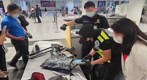 Airport authorities inspect the seized P29.7 million worth of suspected shabu from an arriving passenger at the Ninoy Aquino International Airport Terminal 3 last Saturday afternoon.  