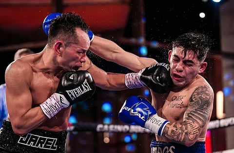 Nonito Donaire (left) and Chilean Andres Campos trade power shots in their interim WBA bantamweight title fight Sunday in Buenos Aires, Argentina.