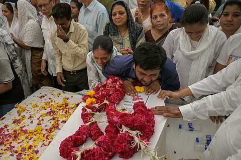 Relatives mourn near the coffins of victims, who were killed in the Air India Flight 171 crash, during a special prayer before the funeral ceremony in Ahmedabad. Grieving families held funerals in India for their relatives who were among at least 279 killed in one of the world’s worst plane crashes in decades.