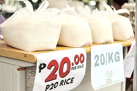 A VENDOR scoops up P20 per kilo of rice outside the Manila Central Post Office in Liwasang Bonifacio, Manila.
