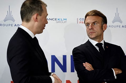 Benjamin Smith (L), Chief Executive Officer of Air France-KLM, and French President Emmanuel Macron attend the signing of an agreement between Air France-KLM and ADP Group during the 55th edition of the International Paris Air Show (Salon international de l'aeronautique et de l'espace - SIAE) at the Paris–Le Bourget Airport, in Le Bourget, north of Paris on June 20, 2025.
