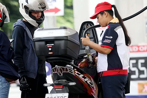 AN attendant tends motorists filling gas at a station in East Avenue in Quezon City on Friday as diesel prices may rise by as much as P5 per liter next week.  