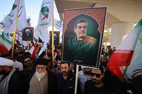 An Iraqi youth holds a picture of Major General Mohammad Rabbani, a commander in the Iranian Revolutionary Guard who was killed in the Israeli bombing of Tehran, during a pro-Iran protest in Baghdad near the green zone, the ultra secured neighborhood hosting the US embassy on June 16, 2025, amid the Israel-Iran escalating conflict.
