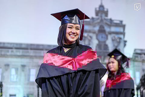 Mikee Quintos marches inside the Quadricentennial Pavilion as one of the 318 graduates of the College of Architecture