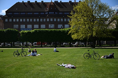 PEOPLE rest in the King’s Garden, the oldest and most visited park in central Copenhagen established in the early 1600s, on a sunny May 8, 2025.