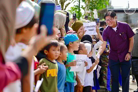 Marawi aid President Ferdinand Marcos Jr. greets young students in Marawi City, where he distributed laptops, Starlink internet kits and school supplies to support the education of 720 displaced learners. The visit was part of his inspection to ensure the city’s continued recovery.