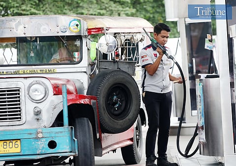 Personnel tend to motorists filling gas at the gasoline station in Brgy. UP Central along Commonwealth avenue in Quezon City.