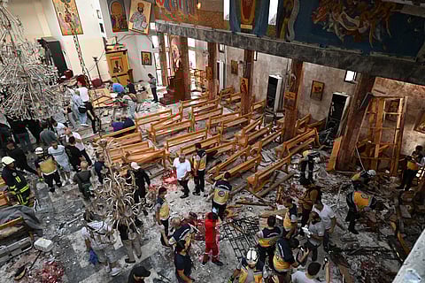 Rescuers inspect the damage at the site of a reported suicide attack at the Saint Elias church in Damascus’ Dwelaa area. Syrian state media reported a suicide attack on a Damascus church that caused casualties, as AFP correspondents at the scene saw first responders transporting people from the site.